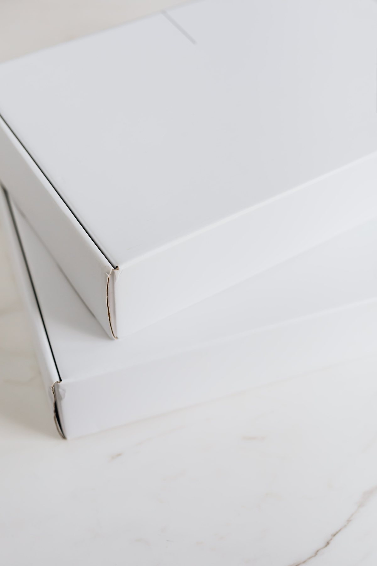 White cartons arranged on a pale stone surface